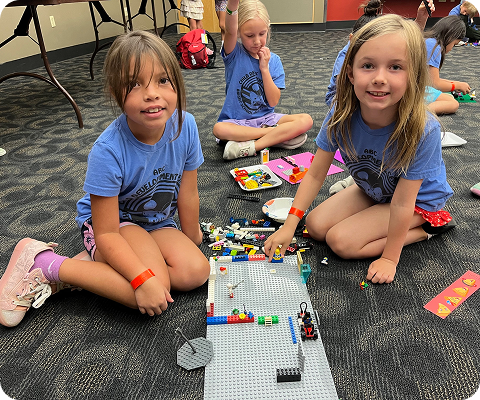 Children building with LEGO bricks during STEM summer camp at ABC Child Development Center in Greeley, CO